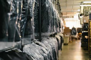 Clothes hanging in dry cleaning warehouse