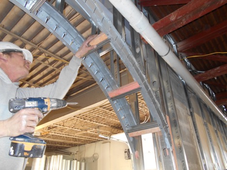 Worker installing supportive archway
