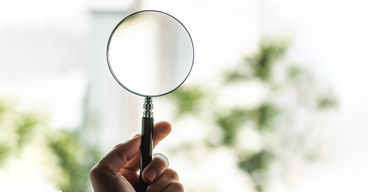 The metaphorical concept of environmental forensics using a magnifying glass to represent the methods used to find out who is responsible for environmental contamination