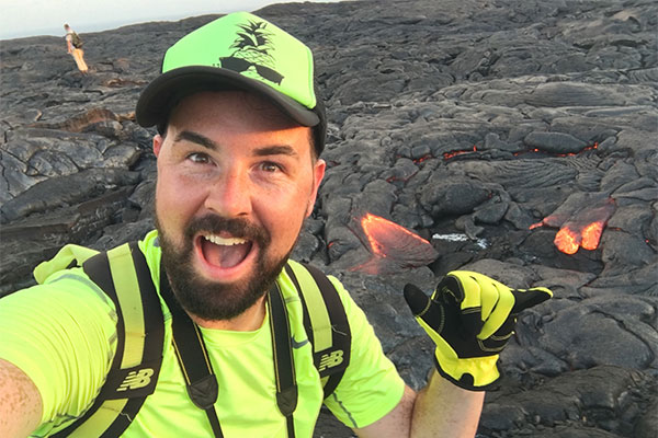 Selfie of Joe Miller standing in front of hot lava at Hawai'i Volcanoes National Park