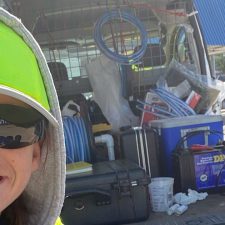 Kenna Hunter standing in front of field work truck