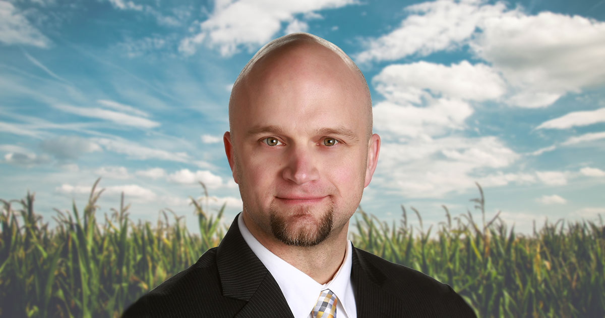 Headshot of Brian Kappen in front of sunlit cornfield