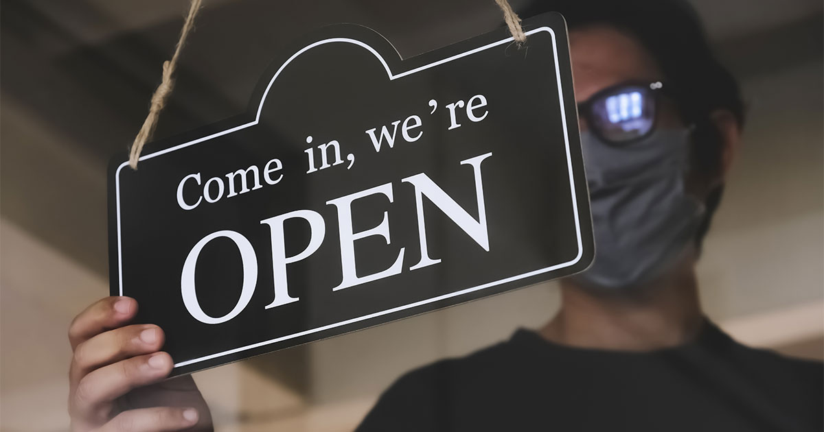 Drycleaner wearing mask opens store during the recession