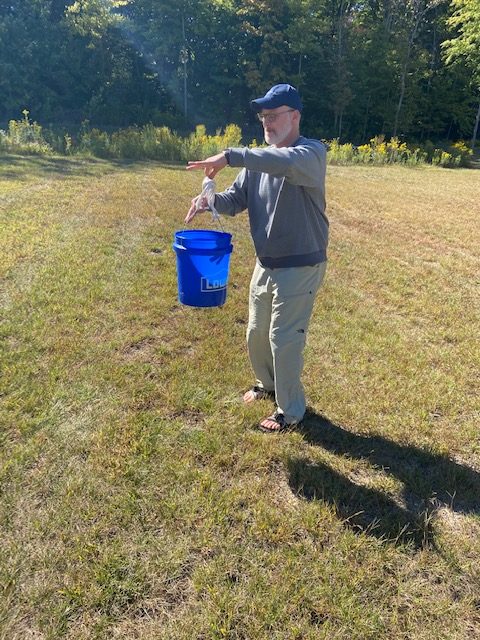 Jeff picking up trash in field