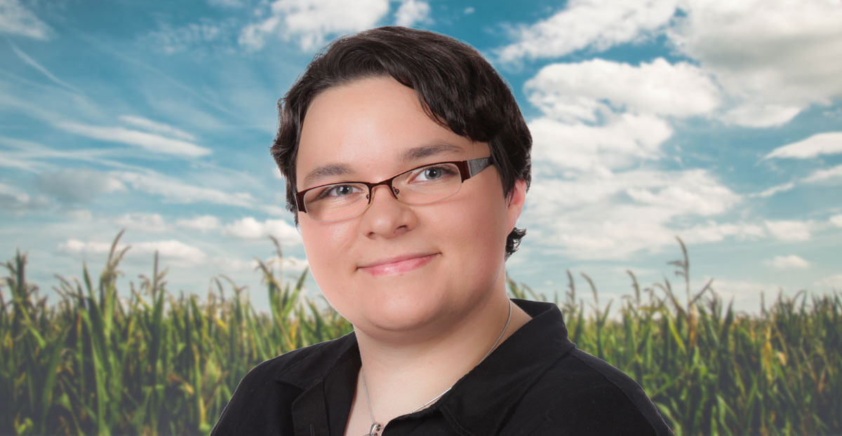 Headshot of Samantha Henderson in front of sunlit cornfield