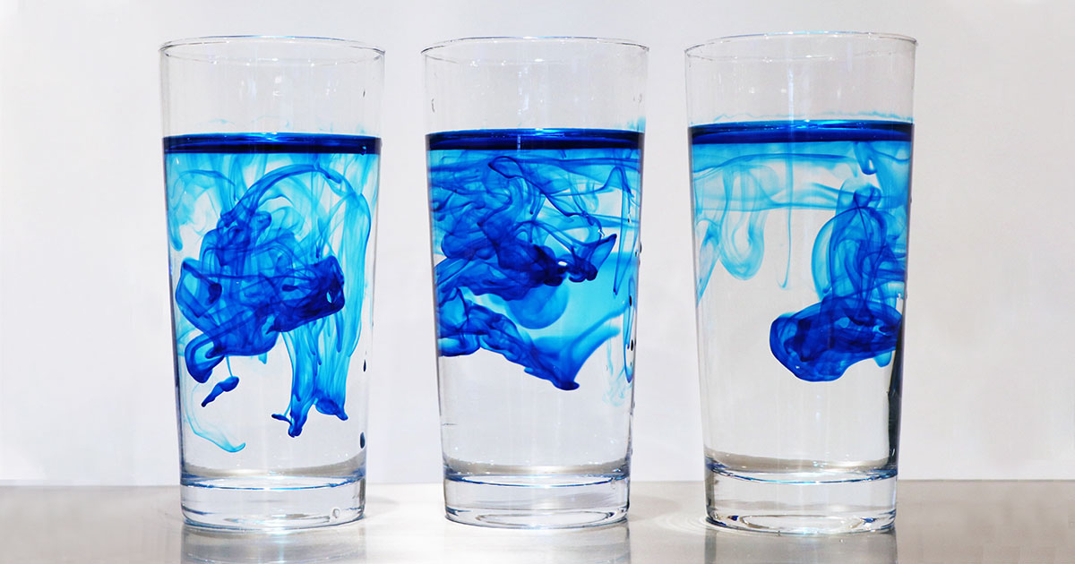 lue ink being diluted by water in three glasses similar to how perc is diluted in groundwater