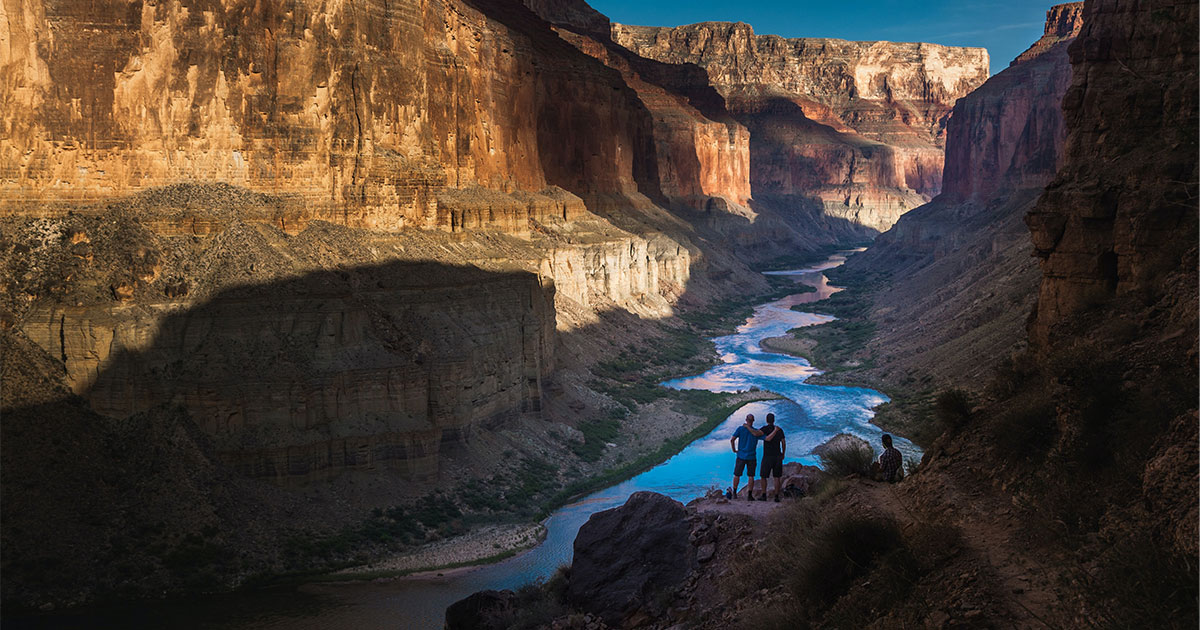 Three hikers make time for nature for 2020 World Environmental Day overlooking the Grand Canyon.