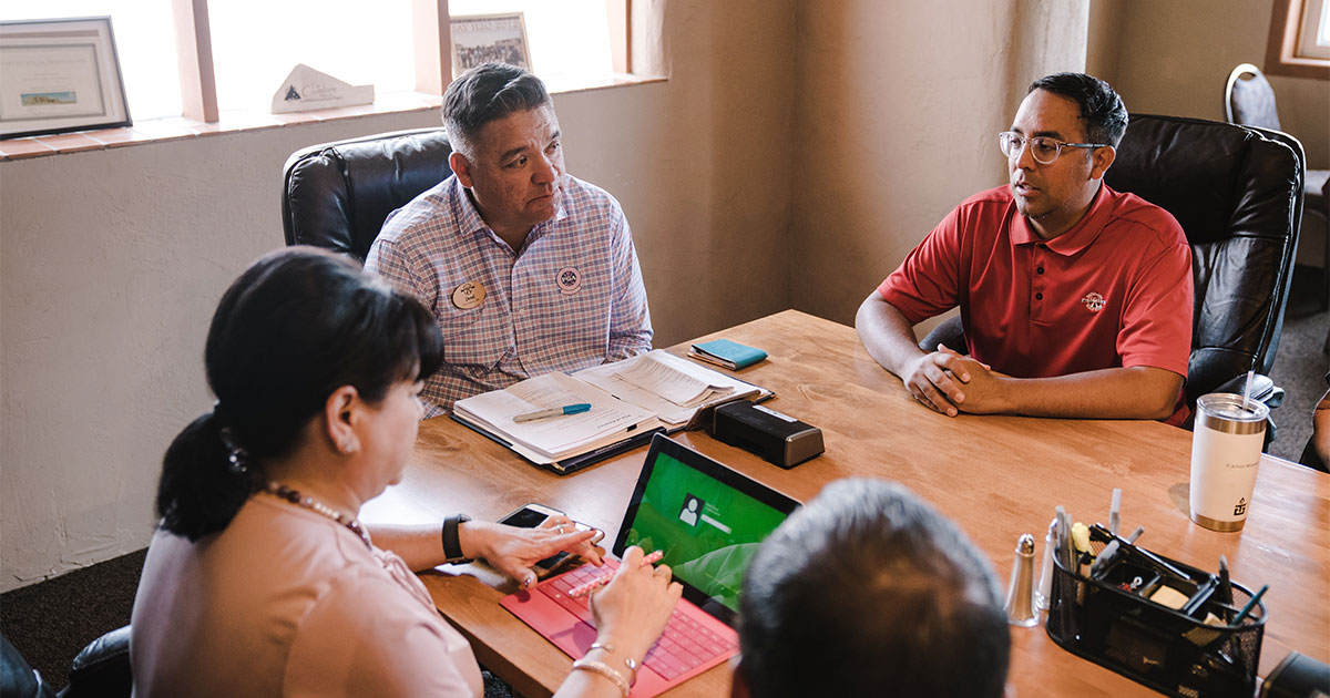 Drycleaner sitting at table negotiating real estate transaction of property and business