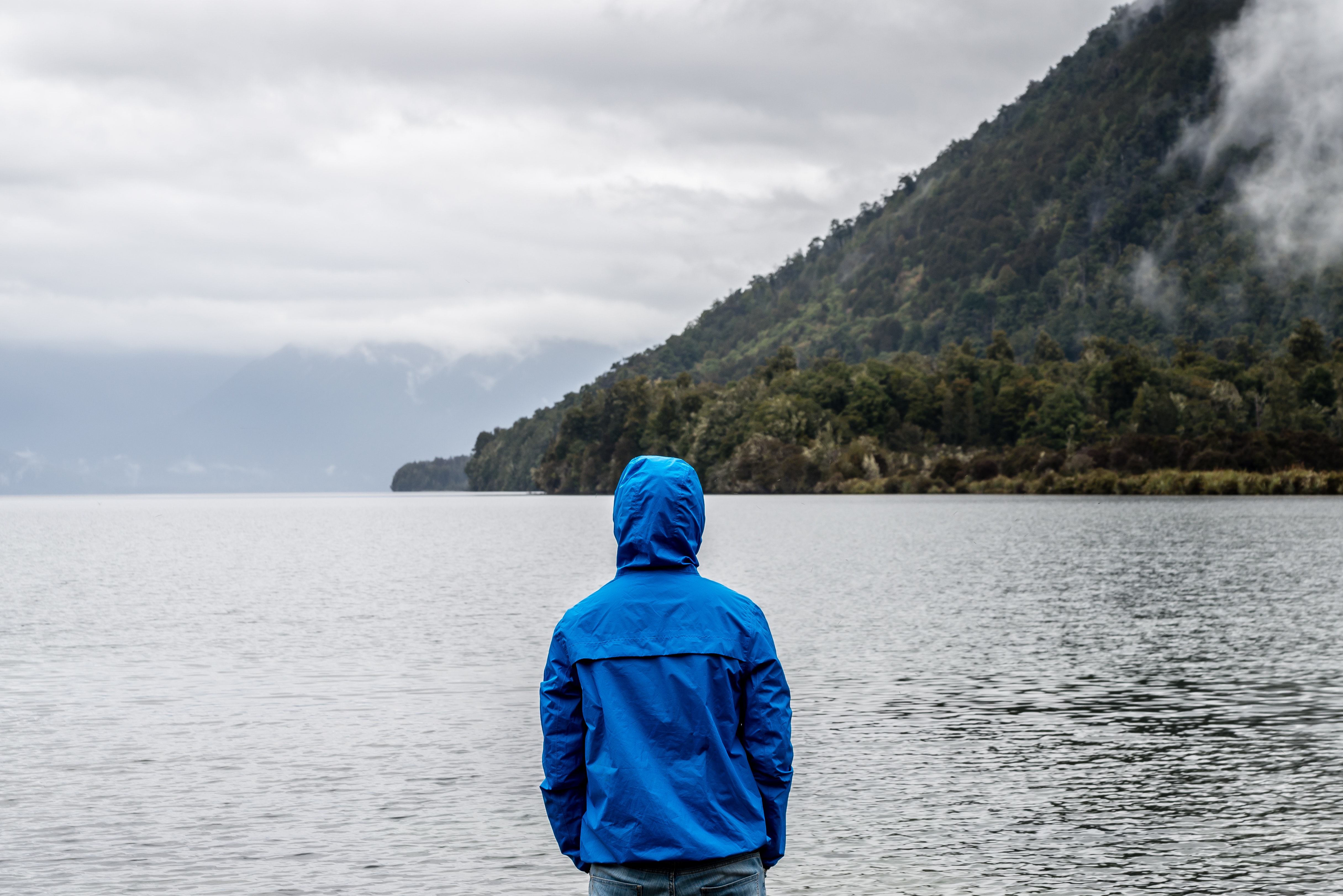 person wearing water-resistant coat potentially treated with PFAS