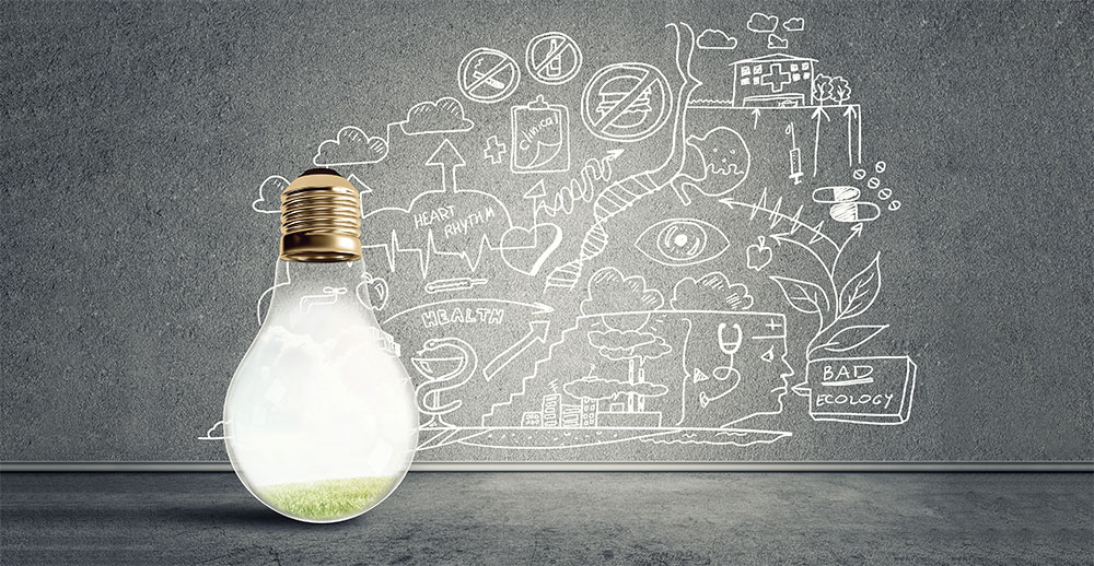 Environmental lightbulb in front of chalkboard with remediation and health-related sketches