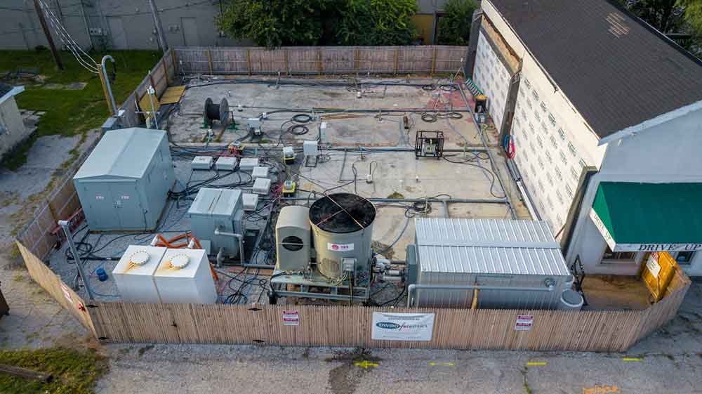 Building with cleanup equipment inside fence