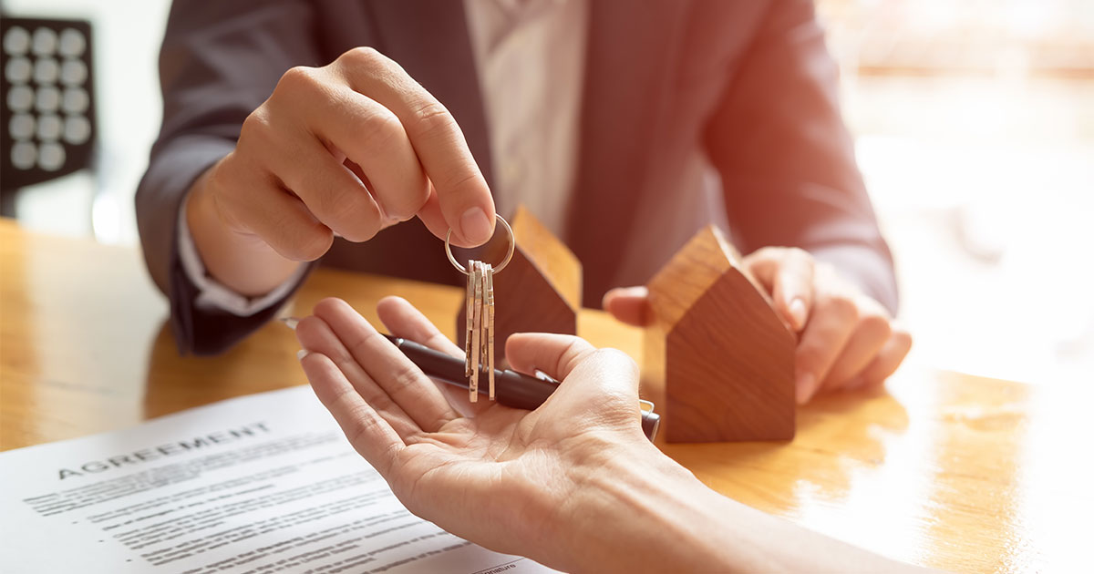 Person handing keys to a drycleaning property over to new property owners