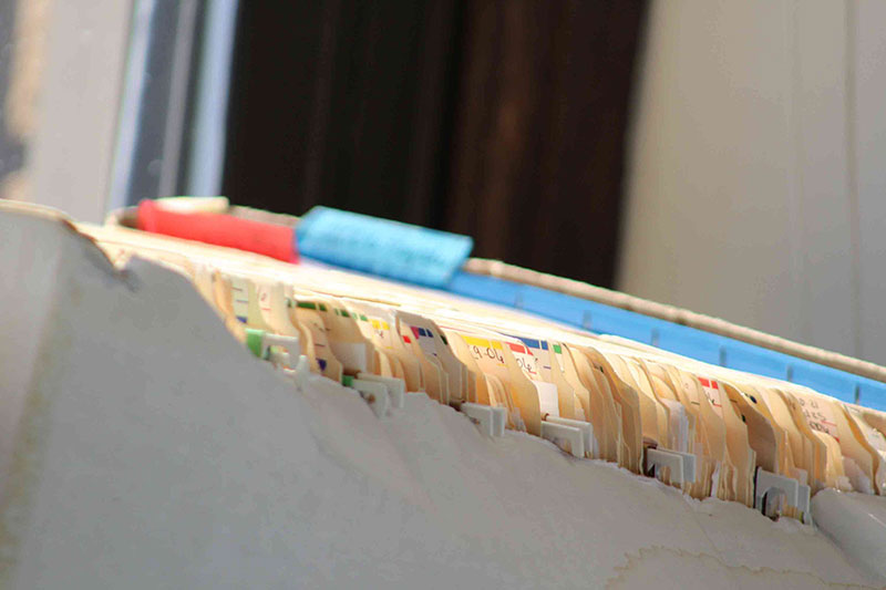 Tabs of old insurance files that can be used as evidence of historical insurance coverage