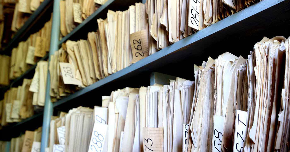 old files on shelves found during insurance archeology that can be used to pay to address environmental contamination